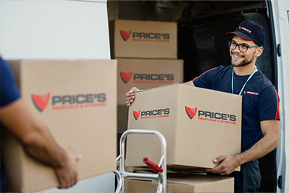 Man carrying boxes that have Price's logo on them